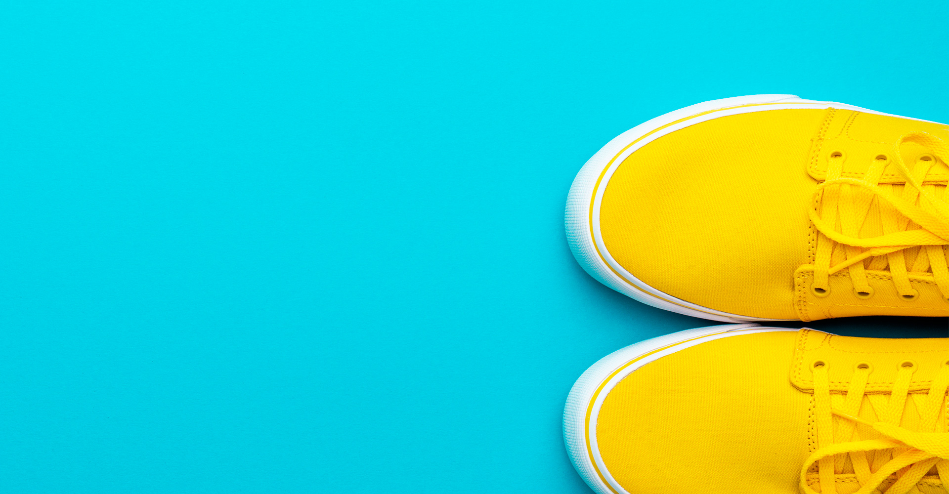 Yellow sneakers on a blue background.