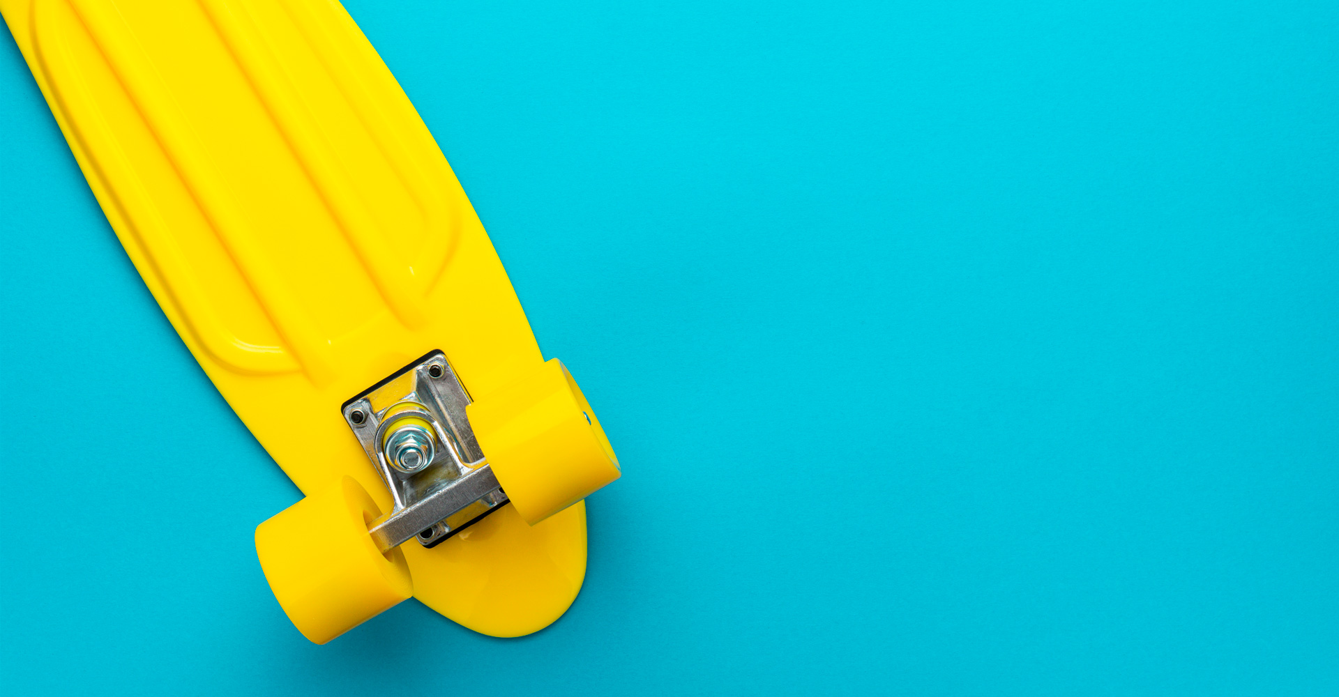 Yellow skateboard on a blue background.